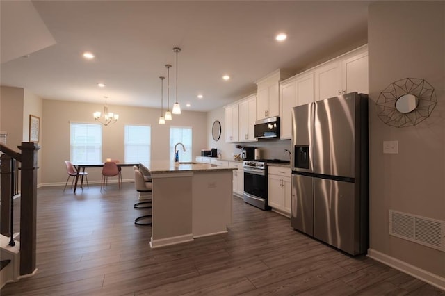 2247 Pink Hawthorn Dr, Buford, GA 30518 - kitchen featuring appliances with stainless steel finishes, a center island with sink, white cabinets, a chandelier, and recessed lighting