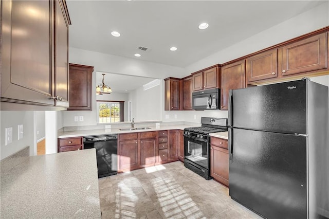 kitchen with hanging light fixtures, sink, kitchen peninsula, and black appliances