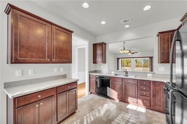 kitchen featuring ceiling fan, sink, hanging light fixtures, and black appliances