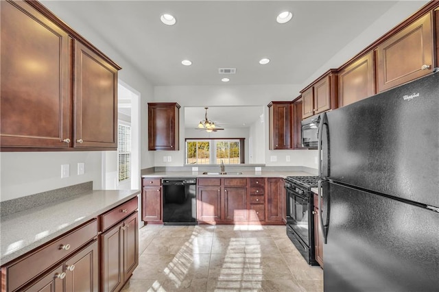 kitchen featuring pendant lighting, light tile patterned floors, sink, and black appliances