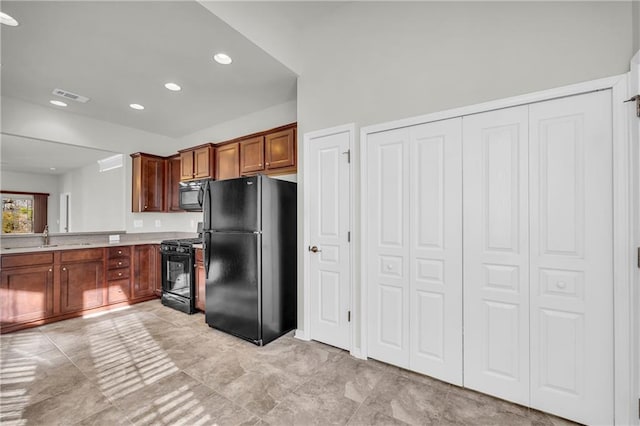 kitchen with sink and black appliances