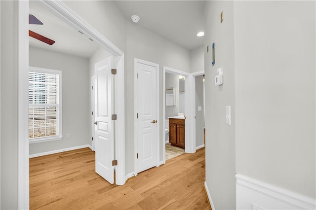 corridor with light hardwood / wood-style floors