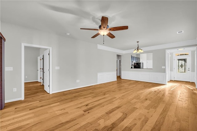 unfurnished living room featuring ceiling fan and light wood-type flooring