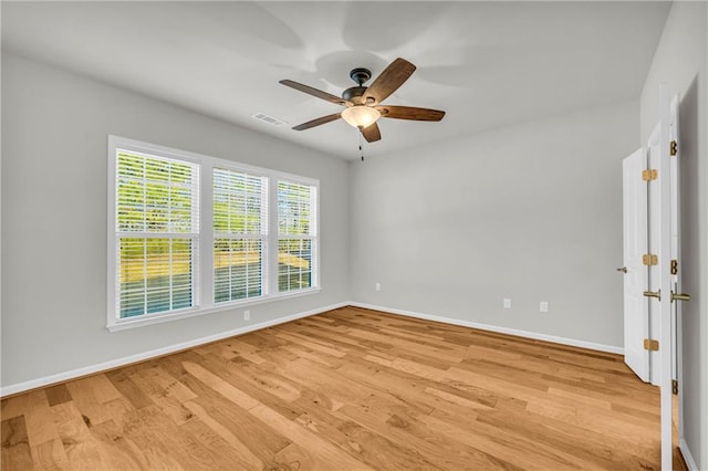 empty room featuring ceiling fan and light wood-type flooring