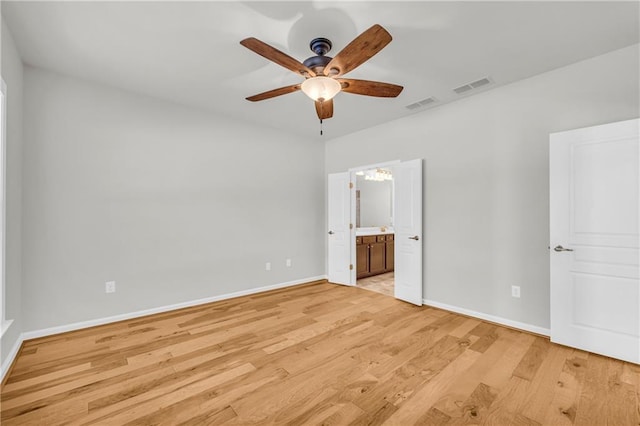 unfurnished bedroom with ensuite bathroom, ceiling fan, and light wood-type flooring