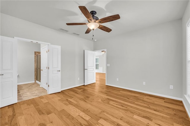 unfurnished bedroom with ceiling fan and light wood-type flooring