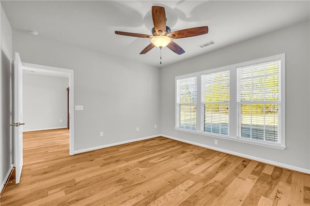 spare room with ceiling fan and light wood-type flooring