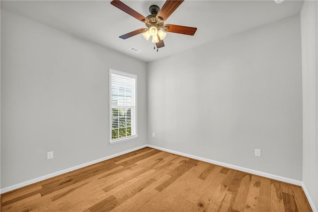 empty room with hardwood / wood-style floors and ceiling fan