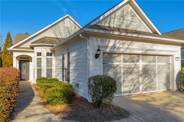 view of side of property with a garage