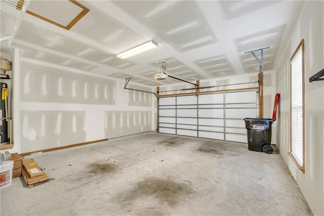 garage featuring a garage door opener and water heater