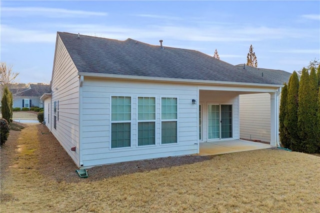 rear view of house featuring a patio and a lawn