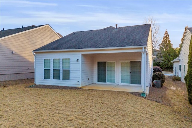 back of property with a patio area and a lawn