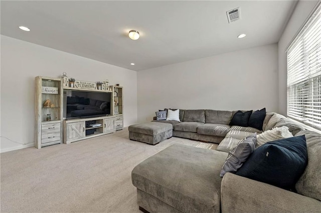 living room featuring light carpet and recessed lighting