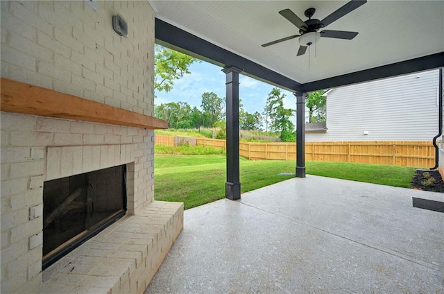 view of patio with an outdoor brick fireplace and a ceiling fan