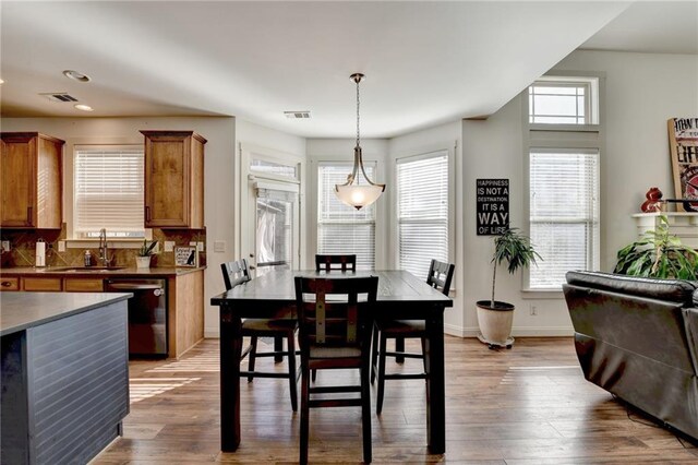 dining area featuring hardwood / wood-style flooring, plenty of natural light, and sink