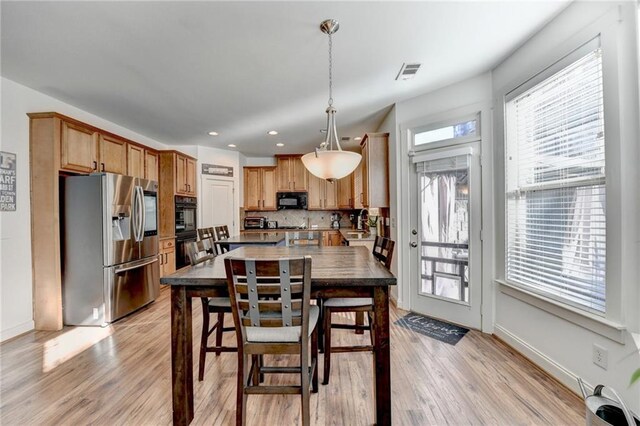 dining room with light wood-type flooring and sink