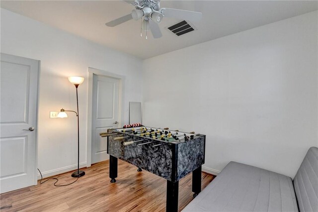 recreation room featuring light hardwood / wood-style floors and ceiling fan