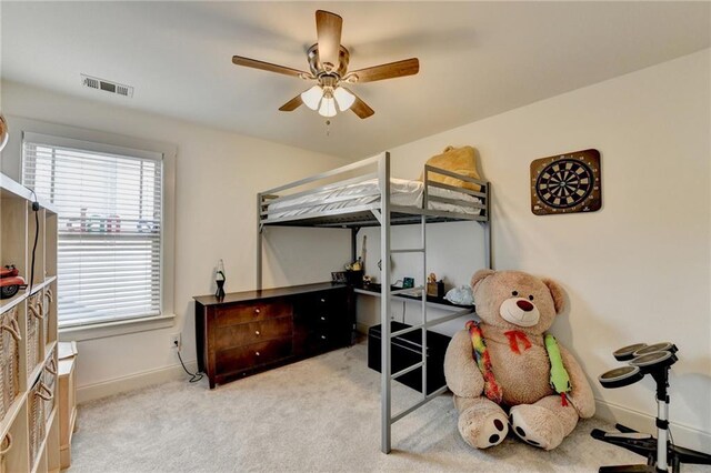 bedroom featuring light carpet and ceiling fan