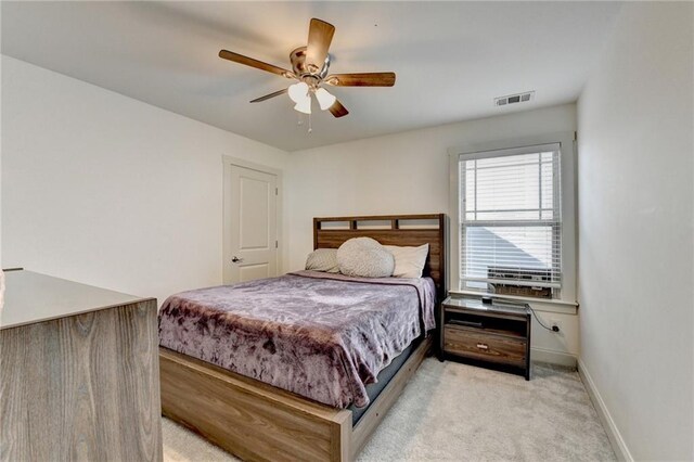 bedroom featuring ceiling fan and light colored carpet