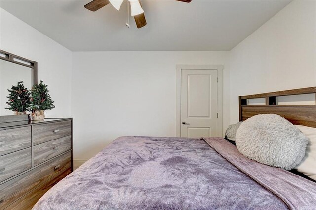 bedroom with hardwood / wood-style floors and ceiling fan