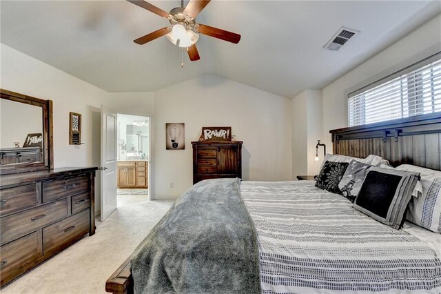 carpeted bedroom with ensuite bath, ceiling fan, and lofted ceiling