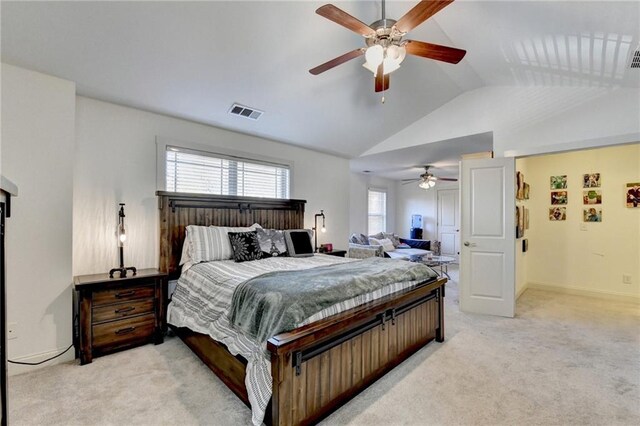 bedroom featuring ceiling fan, light carpet, and vaulted ceiling