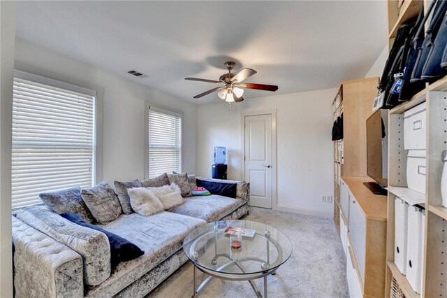 living room with light colored carpet and ceiling fan