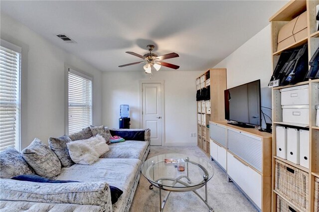 living room with ceiling fan and light colored carpet