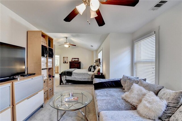 carpeted bedroom featuring ceiling fan and vaulted ceiling