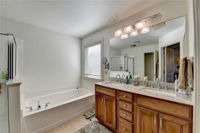 bathroom with plus walk in shower, vanity, and tile patterned floors