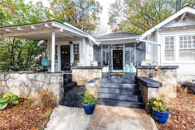 property entrance featuring covered porch and a chimney