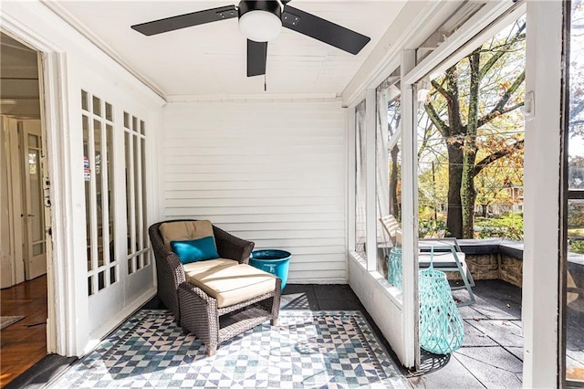 sunroom featuring ceiling fan