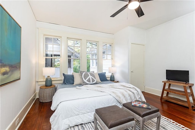 bedroom with a ceiling fan, wood finished floors, and baseboards