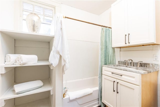 bathroom featuring vanity and shower / bathtub combination with curtain