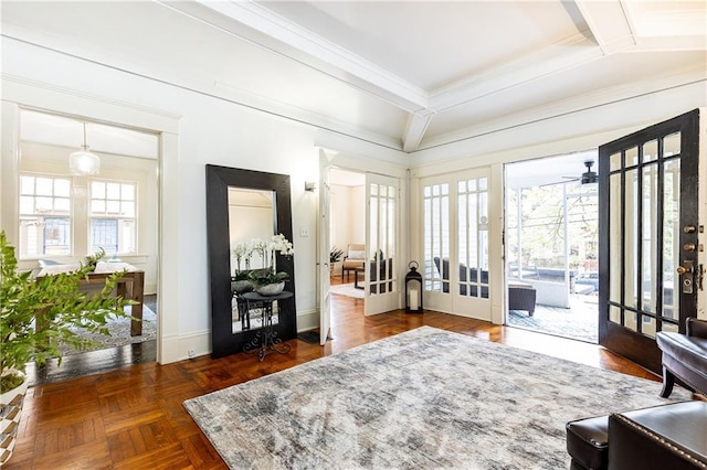 interior space featuring a ceiling fan, baseboards, and ornamental molding