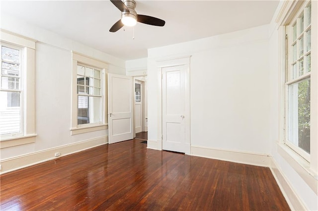 unfurnished room featuring hardwood / wood-style flooring, baseboards, and ceiling fan