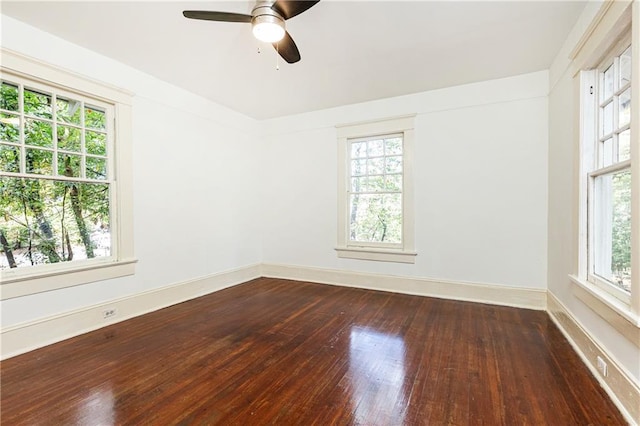 unfurnished room with baseboards, wood-type flooring, and a ceiling fan