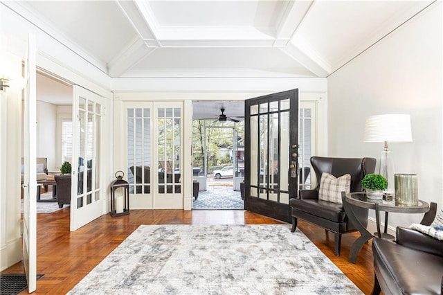 living area with beam ceiling, french doors, and ornamental molding