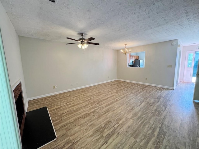 3589 Main Station Dr SW, Marietta, GA 30008 - unfurnished living room with a textured ceiling, hardwood / wood-style flooring, and ceiling fan with notable chandelier