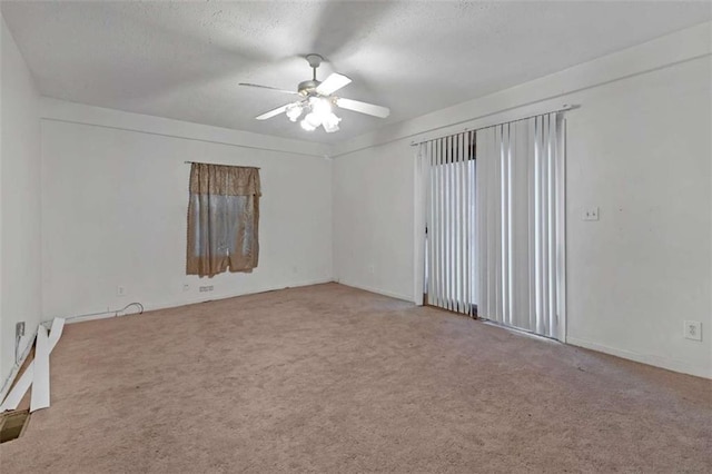 spare room featuring carpet floors and ceiling fan