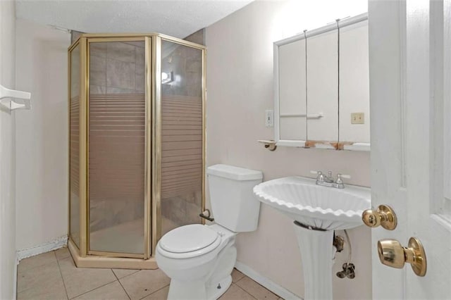 bathroom featuring tile patterned flooring, toilet, and an enclosed shower