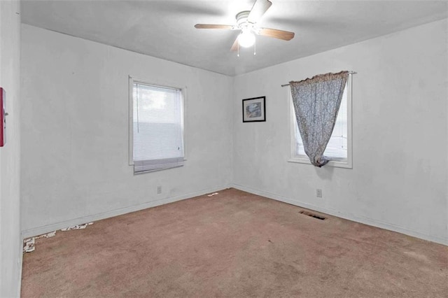 unfurnished room featuring carpet and ceiling fan