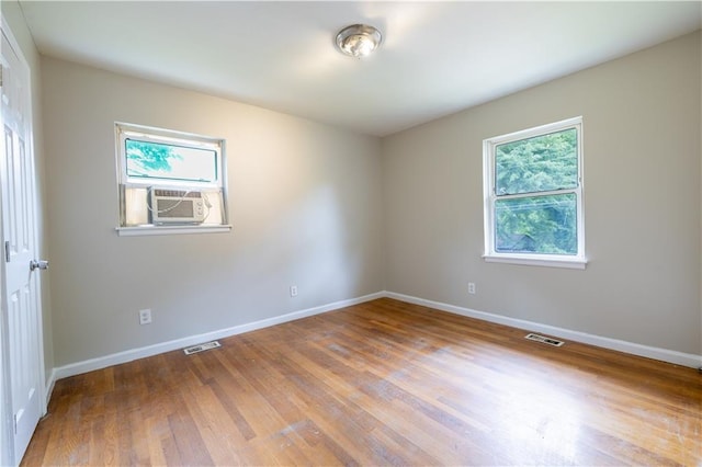 115 Delmoor Dr NW, Atlanta, GA 30311 - empty room with plenty of natural light, baseboards, wood finished floors, and cooling unit