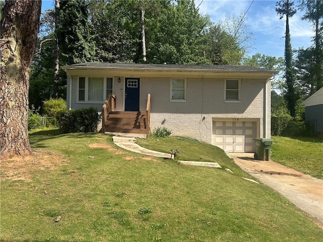 115 Delmoor Dr NW, Atlanta, GA 30311 - view of front facade with an attached garage, brick siding, concrete driveway, and a front yard