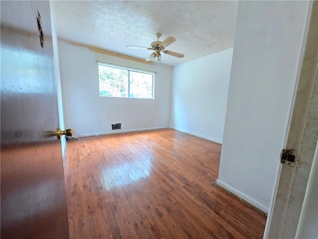 empty room featuring hardwood / wood-style floors and ceiling fan