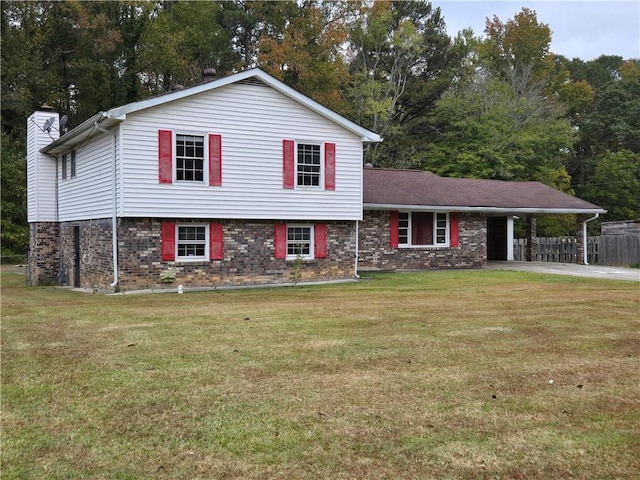 split level home featuring a front lawn and a carport