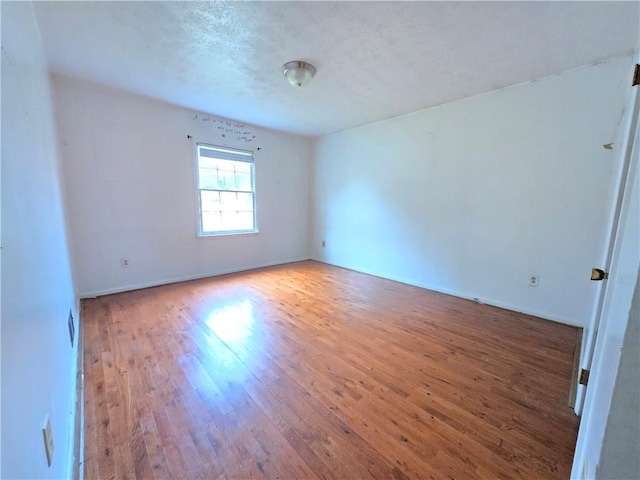 spare room featuring hardwood / wood-style floors