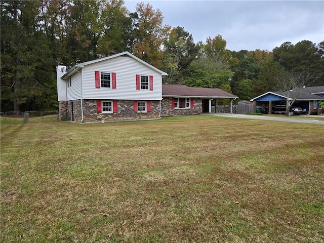 split level home with a front yard and a carport