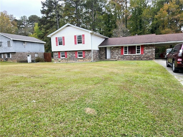 tri-level home with a front lawn and a carport