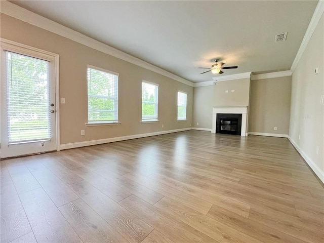 5119 Aylesbury Ct, Hoschton, GA 30548 - unfurnished living room featuring a glass covered fireplace, a ceiling fan, crown molding, and light wood-style flooring